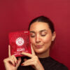 Image of woman holding packaging of KANHA Life Fast-Acting NANO Cran Pom D9 Gummies