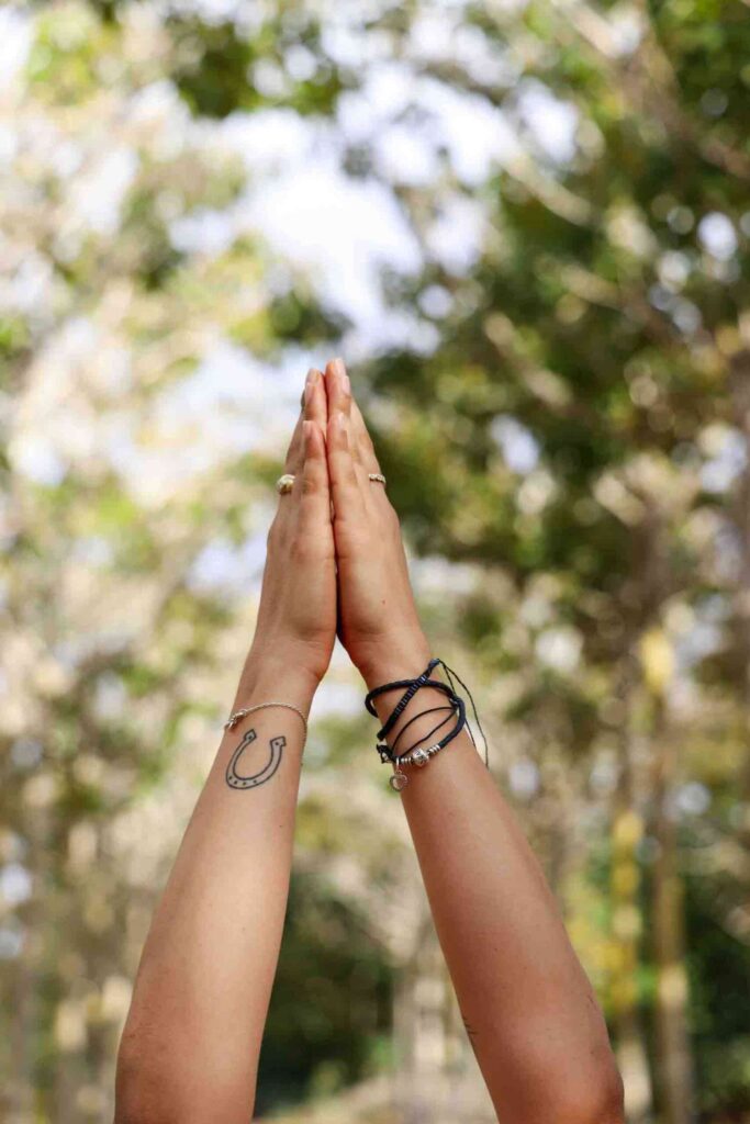 Lifestyle image of two hands stretched upward in a prayer or high five position