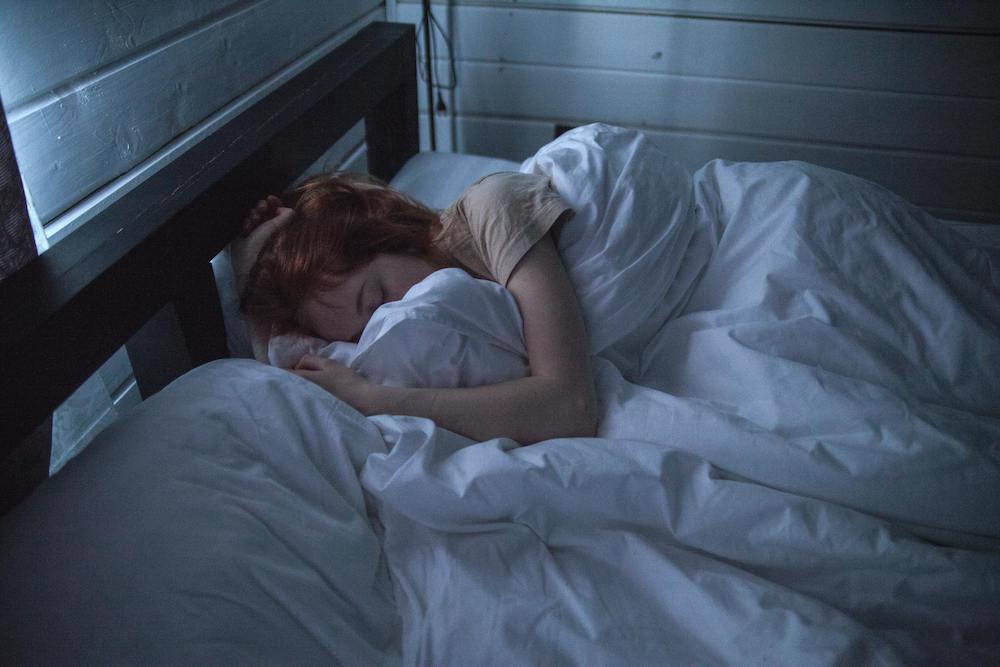 Lifestyle image of someone asleep in bed