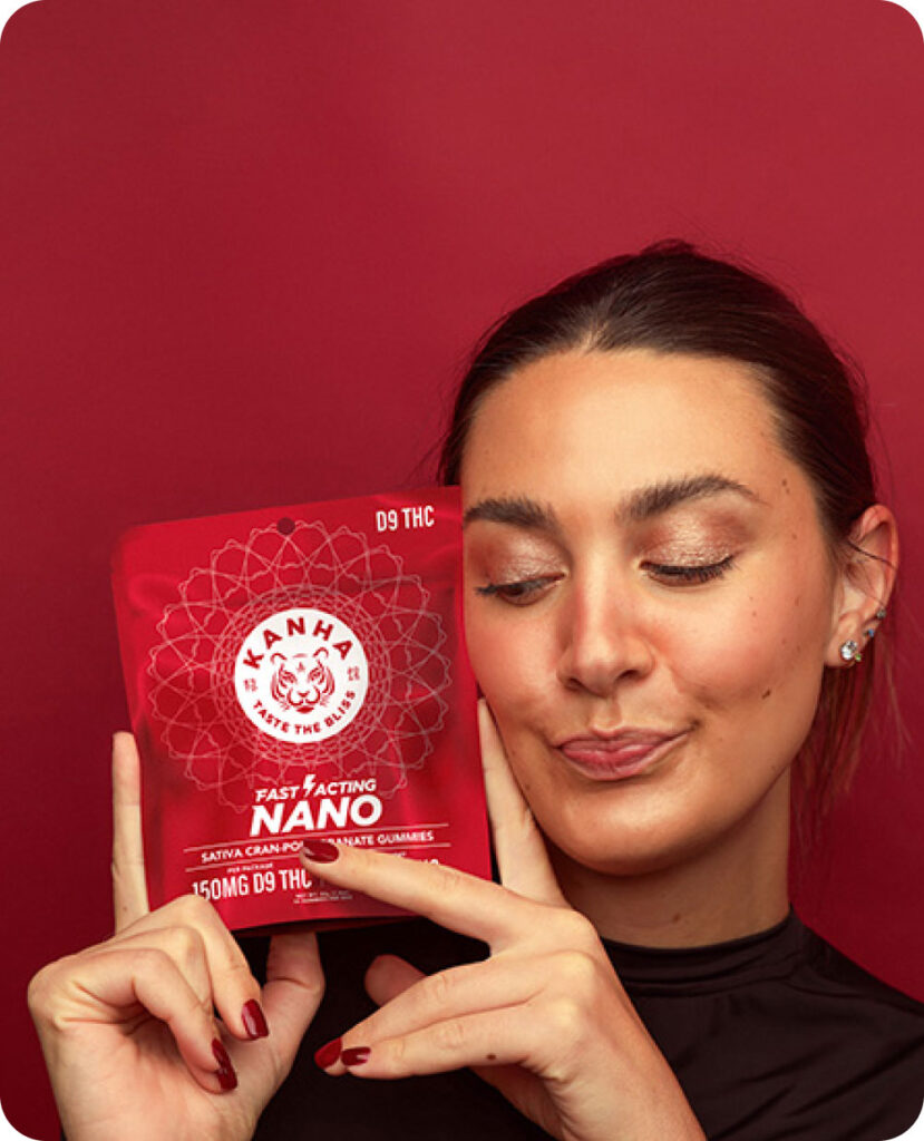 Image of woman holding packaging of KANHA Life Fast-Acting NANO Cran Pom D9 Gummies
