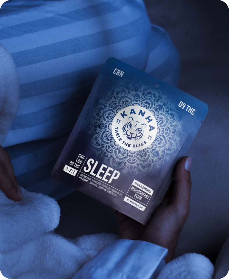 Image of woman holding packaging of KANHA Life FX Sleep Gummies